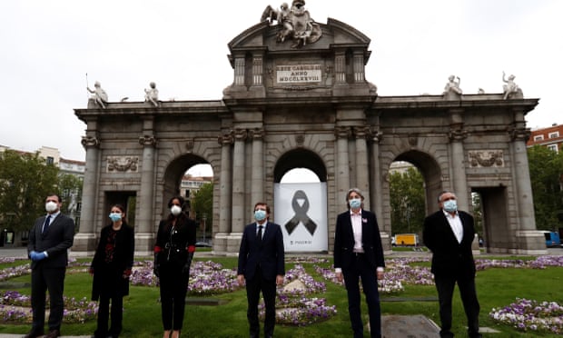 Officials in Madrid observe a minute silence in memory of coronavirus fatalities.