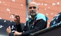 Pep Guardiola smokes a cigar during Manchester City’s latest title parade on Sunday