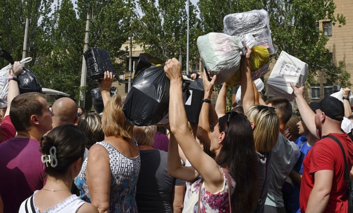 People receive donated items such as medicines and clothes in Zaporizhzhia, Ukraine