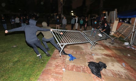 Protesters try to remove barricades at a pro-Palestinian encampment