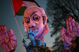 Washington, DC, USAn activist dressed as the Statue of Liberty is pulled in shackles near a large effigy of Israeli prime minister Benjamin Netanyahu during a rally in support of Palestinians near the White House