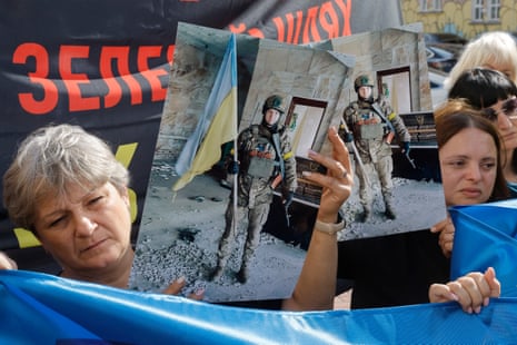 People hold placards and portraits during a rally in support of prisoners of war and missing people who were fighting in the Kursk region of Russia, calling for authorities to find and return their relatives from Russian captivity, in downtown Kyiv, Ukraine.