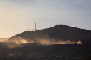 A truck sends up a dust cloud