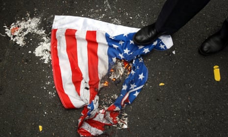 An Iranian steps over a burning US flag in Tehran. Washington’s fractured relationship with Iran will be a key issue in Biden’s nuclear policy.