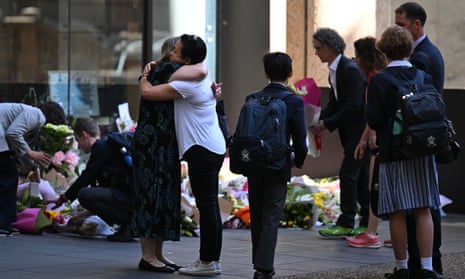 Students of St Andrew’s Cathedral School lay flowers at the entrance to the school in the Sydney CBD, on Monday