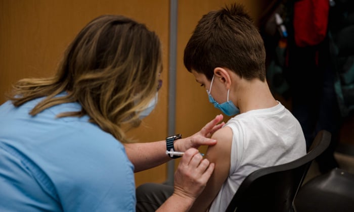 An 11-year-old child receives the Pfizer vaccine in Montreal.