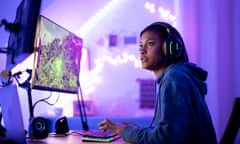 Young black female gamer playing at night