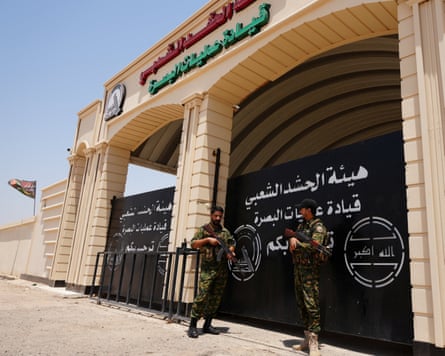 Members of Iraq’s Popular Mobilisation Forces stand guard outside the Basra Operations Command headquarters, Iraq, on Wednesday.