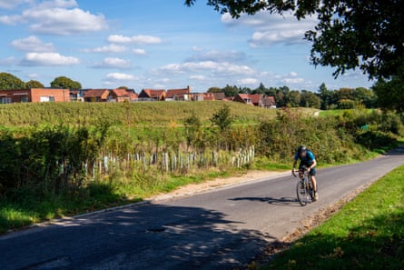 A cyclist on a road on the estate’s perimeter.