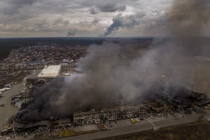 Russia-Ukraine war: Zelenskiy vows to ‘punish atrocities’ as family dies trying to evacuate Irpin – live | World news 2 A factory and a store burn after having been bombarded in Irpin.