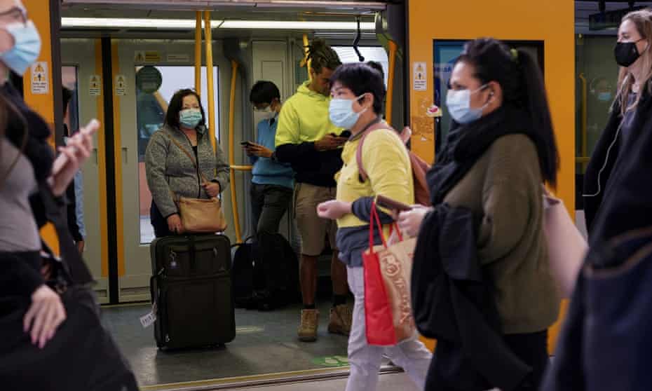 Commuters wear protective face masks on public transit at Central Station