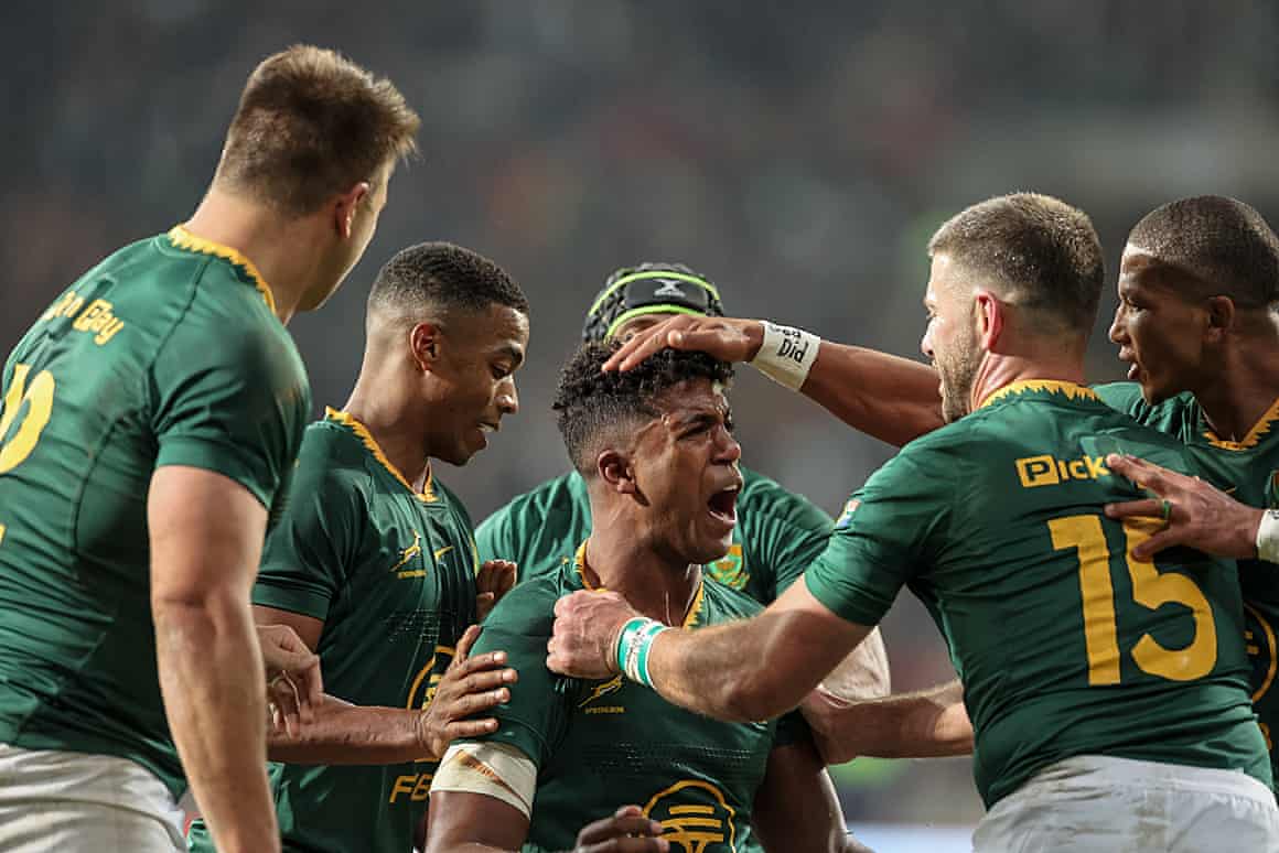 Canan Moodie celebrates with teammates after scoring a try against Italy