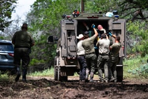 people load a body into a vehicle