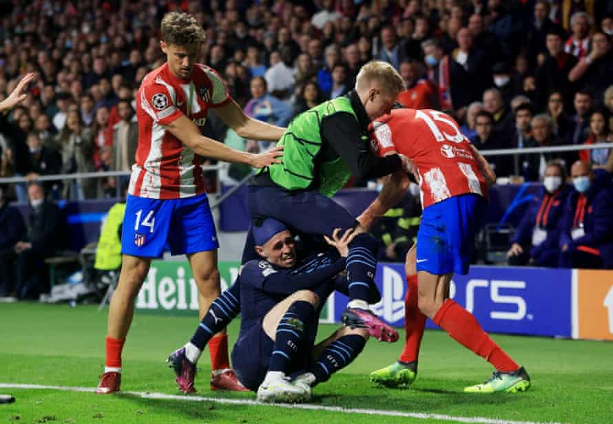 Manchester City’s Phil Foden and Oleksandr Zinchenko clash with Atlético Marcos Llorente and Stefan Savic.