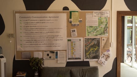 The noticeboard in the community centre with a map and village rules