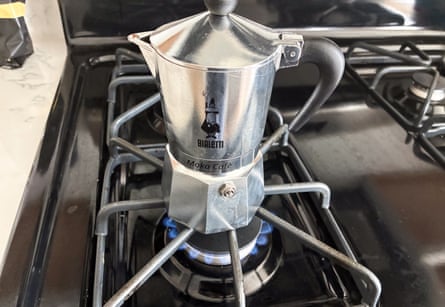 A photo of a Moka pot on a gas stovetop