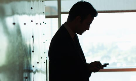 Silhouette of businessman using cell phone