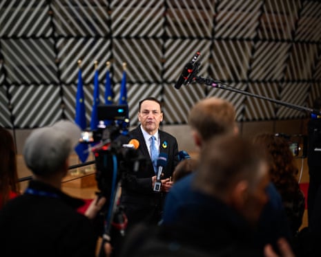 Poland's foreign minister Radoslaw Sikorski speaks to the press as he arrives for the EU Foreign Affairs Council in Brussels.