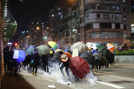 Protesters react to tear gas fired by riot police in the Sham Shui Po district of Hong Kong.