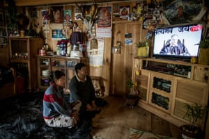 Lhakpa and his daughter, Tshering Yangchen, watch TV in their house in Phobjikha Valley
