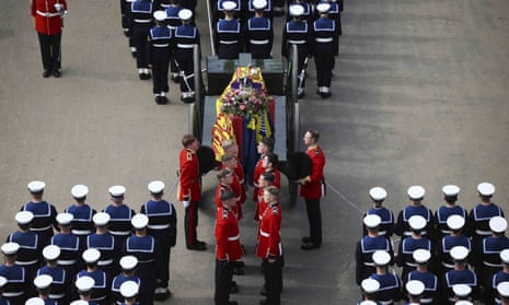 Pallbearers stand to transfer the coffin of Queen Elizabeth II into the state hearse before it is driven to Windsor.