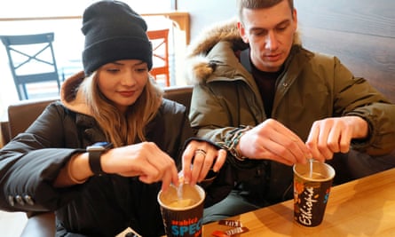 Alexandr Kudlay and Viktoria Pustovitova drink coffee in a cafe in Kharkiv