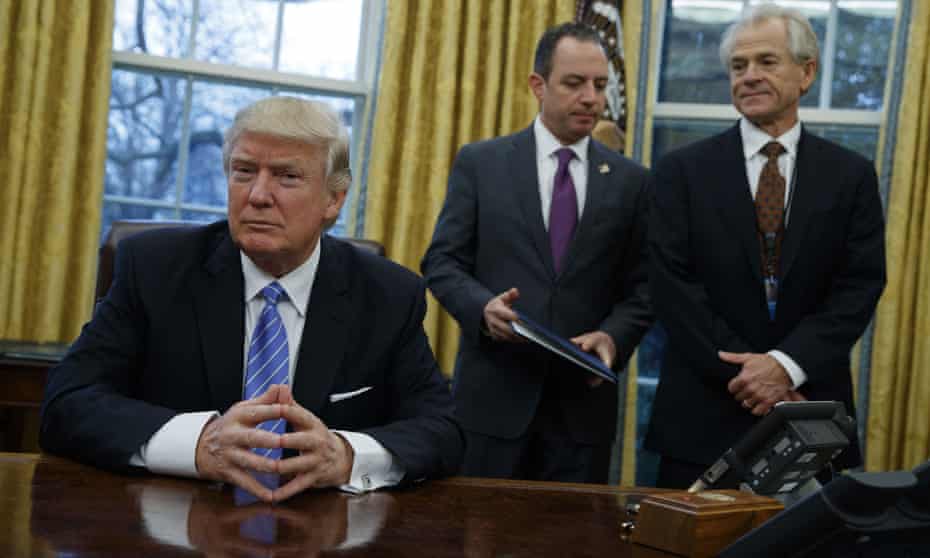Donald Trump with White House chief of staff Reince Priebus (centre) and National Trade Council adviser Peter Navarro (right).