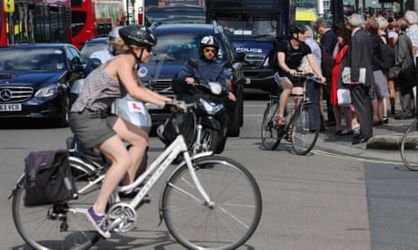 A female cyclist crossing a busy junction