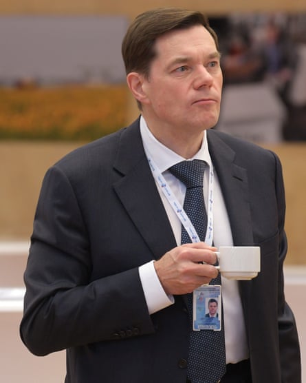 Alexei Mordashov in suit holding tea/coffee cup