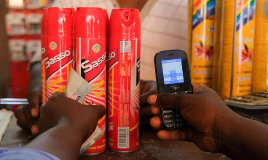 A customer pays by phone for mosquito sprays in Accra, Ghana.