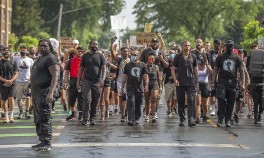 Protesters march towards the barricade of the George Floyd Memorial in Minneapolis, Minnesota after marching 8 miles over 5 hours in 95F (35C) heat.