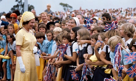 The Queen meets flag-waving schoolchildren in Brisbane, during her 1977 tour.