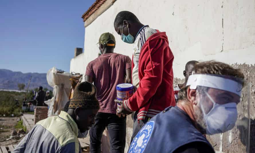Doctors of the World workers distribute food to migrants from Mali in Nijar, southern Spain.
