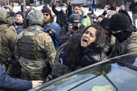 ICE agents arresting a woman after smashing her car windows for allegedly blocking the street during an Immigration Enforcement Operation in Minneapolis, Minneapolis, MN, U.S., January 13, 2026. (Photo by Mostafa Bassim/Anadolu via Getty Images)