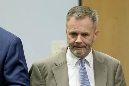 A white man in a suit with a pensive expression.