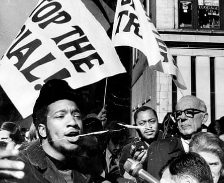 Fred Hampton, left, and Dr. Benjamin Spock, right, attend a rally against the trial of eight people accused of conspiracy to start a riot at the Democratic National Convention.