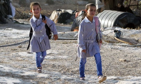 Palestinian girls walk to school in the West Bank village of Susya.