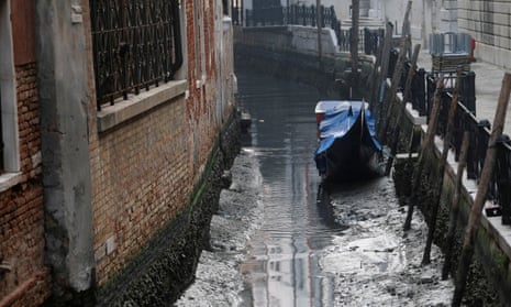 A gondola pictured in a noticeably empty canal during a severe low tide in Venice, Italy.