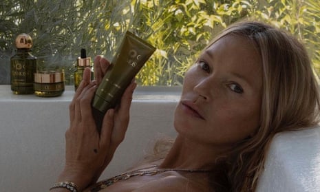 Kate Moss holding skincare product in a bath