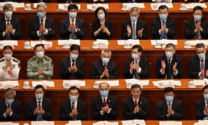 Attendees of the Second Plenary Session of the National People’s Congress clap their hands during a speech on May 25