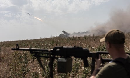 Ukrainian soldiers fire BM-21 grad rockets towards the trenches of Russian forces in the Donetsk area.