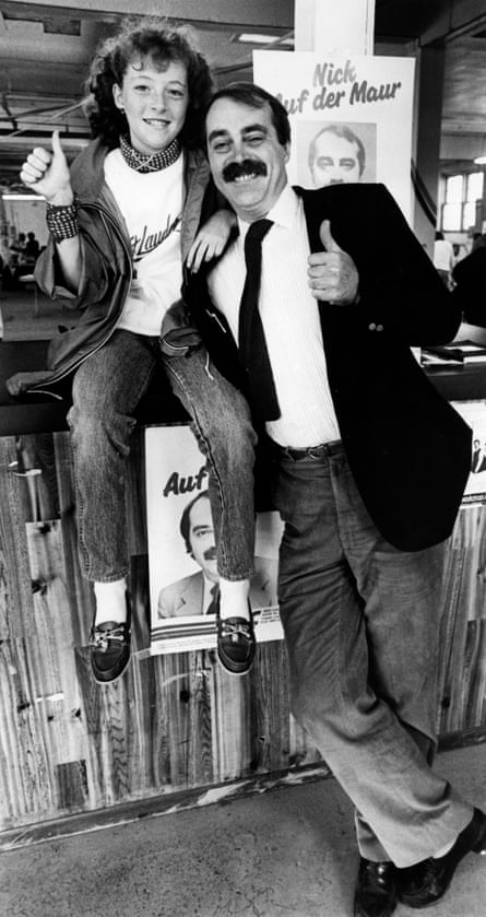 Dad, with luxuriant moustache, and daughter give the camera a thumbs up