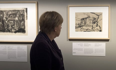 Chancellor Angela Merkel looks at an image from the Theresienstadt concentration camp during a preview of Art from the Holocaust in Berlin.