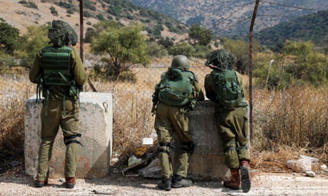 Israeli soldiers take positions near the Israeli military base of Har Dov on Mount Hermon, a strategic and fortified outpost at the crossroads between Israel, Lebanon, and Syria, on 10 October 2023.