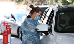 A nurse administers a Pfizer vaccine at a drive-through vaccine hub in Sydney.