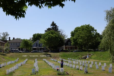 A young boy prays at the Say Their Names memorial on 27 May during the annual Rise and Remember Festival marking the third anniversary of the murder of George Floyd by a police officer in Minneapolis, Minnesota.