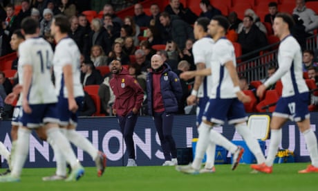 A smiling England interim head coach Lee Carsley with his assistant Ashley Cole after the fourth England goal.