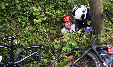 Switzerland’s Marc Hirschi receives medical attention after falling into a ditch during the first stage.