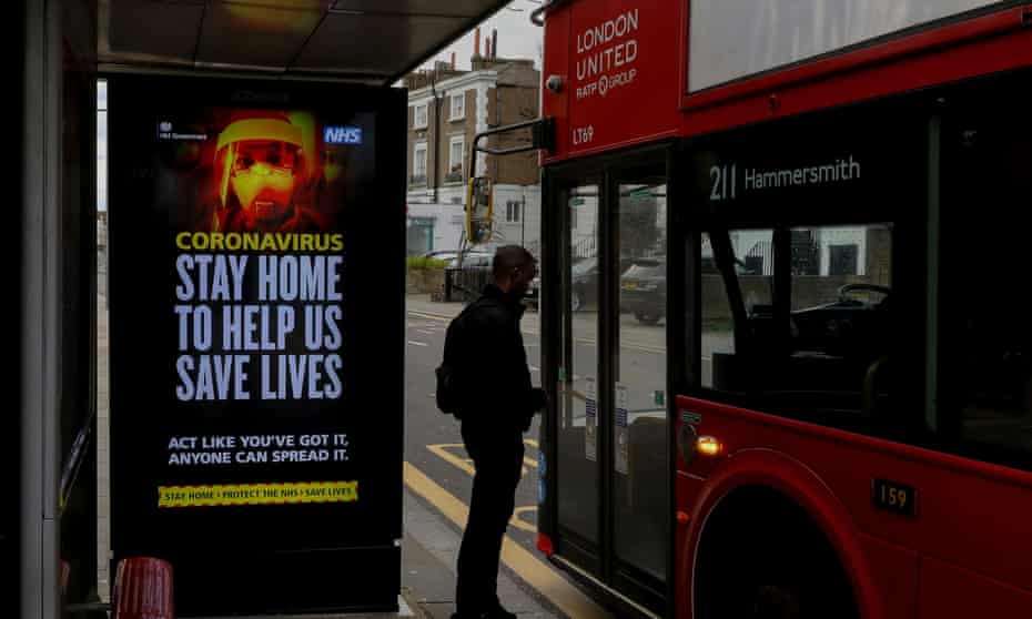 A UK government warning is seen at a bus stop in London.