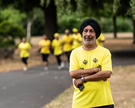 He poses for the camera wearing yellow T-shirt and black turban